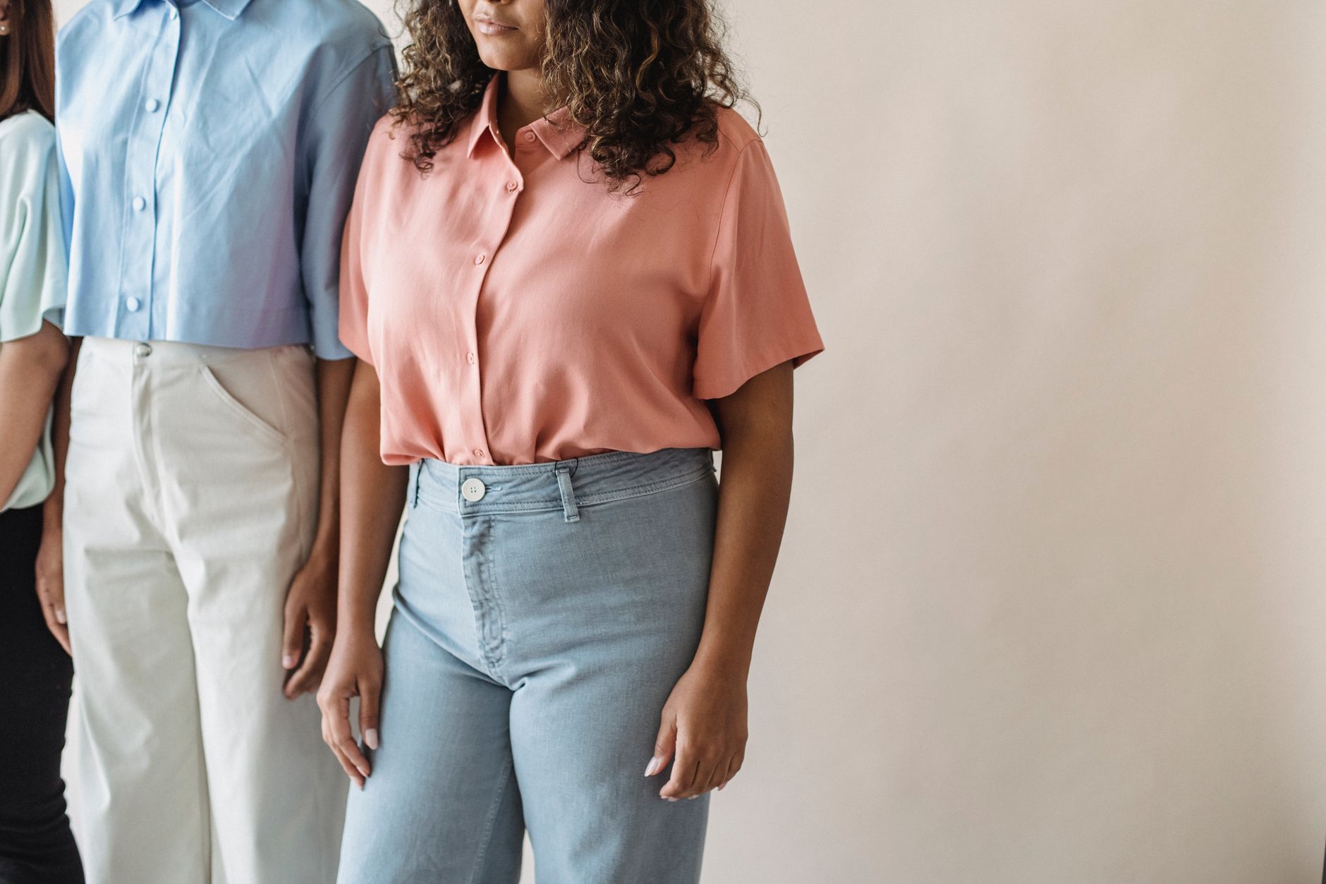 Stylish fashion image highlighting colorful shirts worn by a group of women.