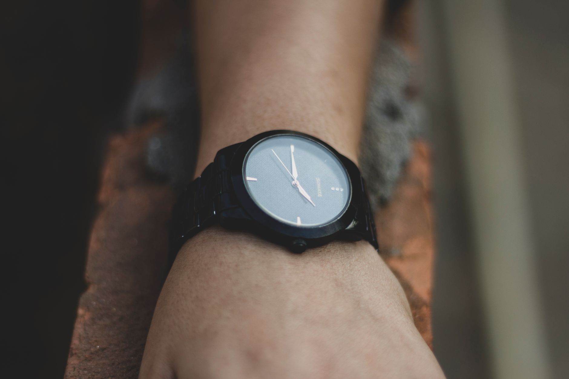 Minimalist black watch on wrist showcasing elegant design and precise timekeeping.