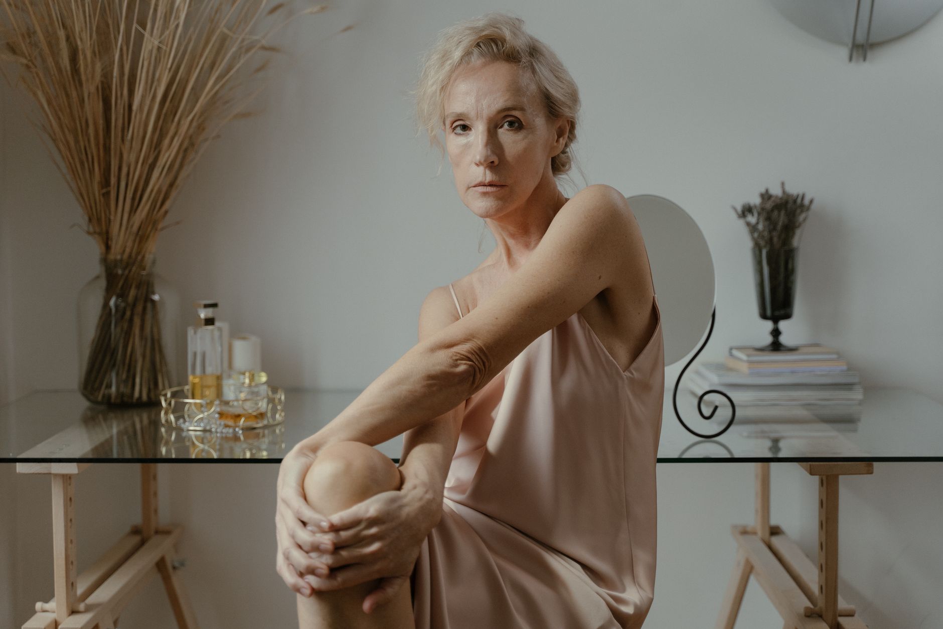 A graceful senior woman posing elegantly indoors, epitomizing elegance and confidence.