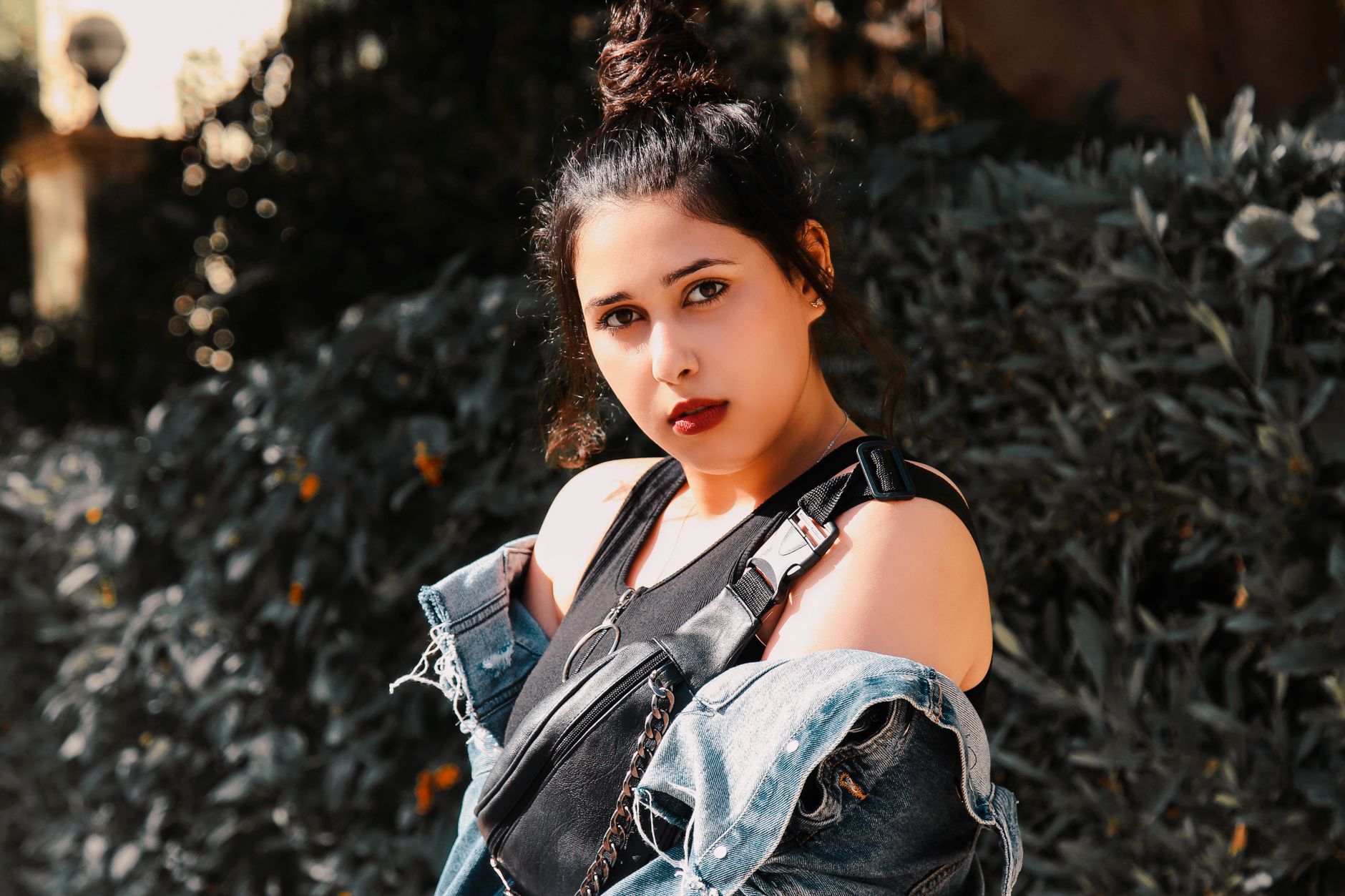 Outdoor portrait of a stylish plus-size woman in casual fashion wear with a bumbag.