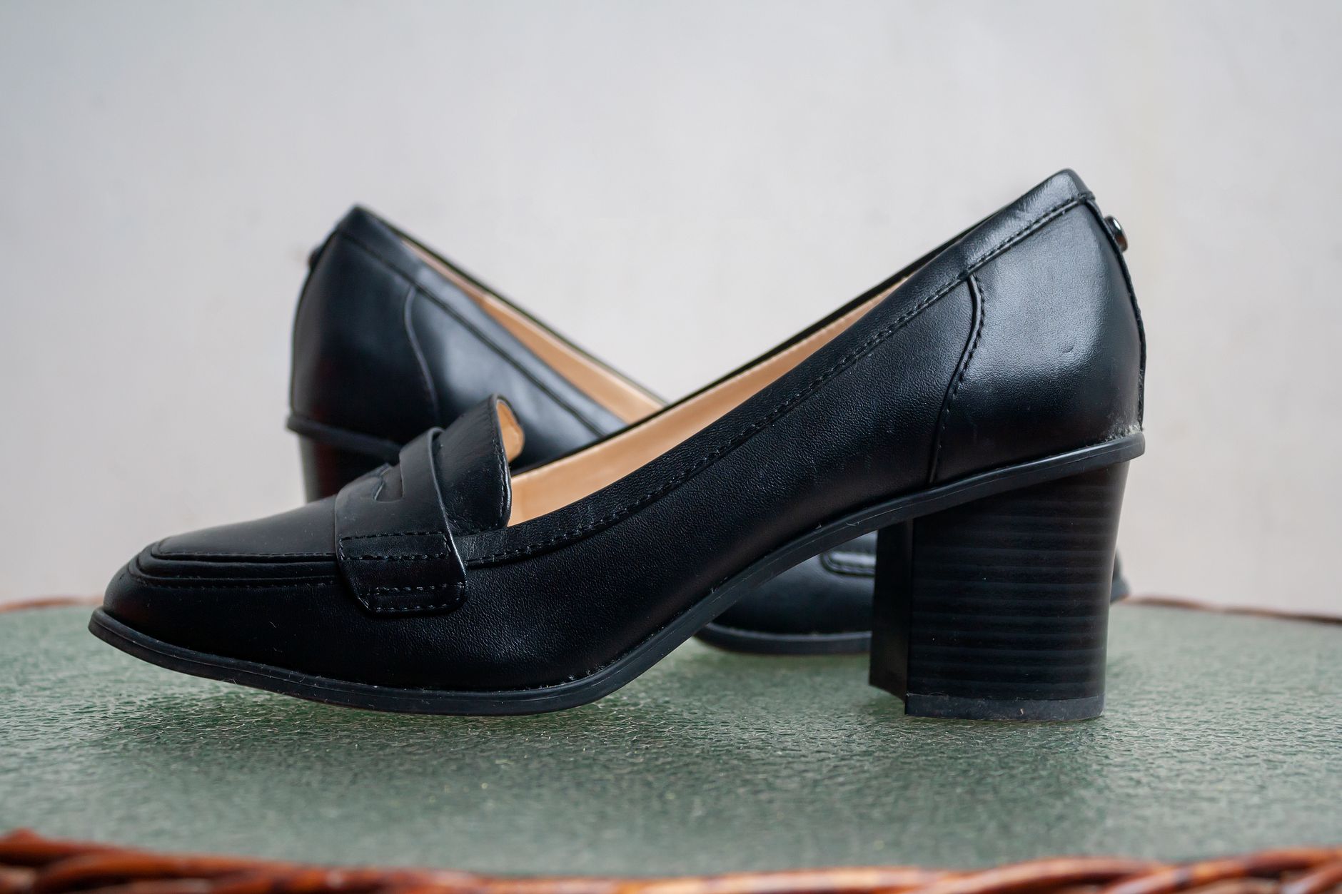 Stylish black leather loafers with comfortable block heels, perfect for formal and casual wear.