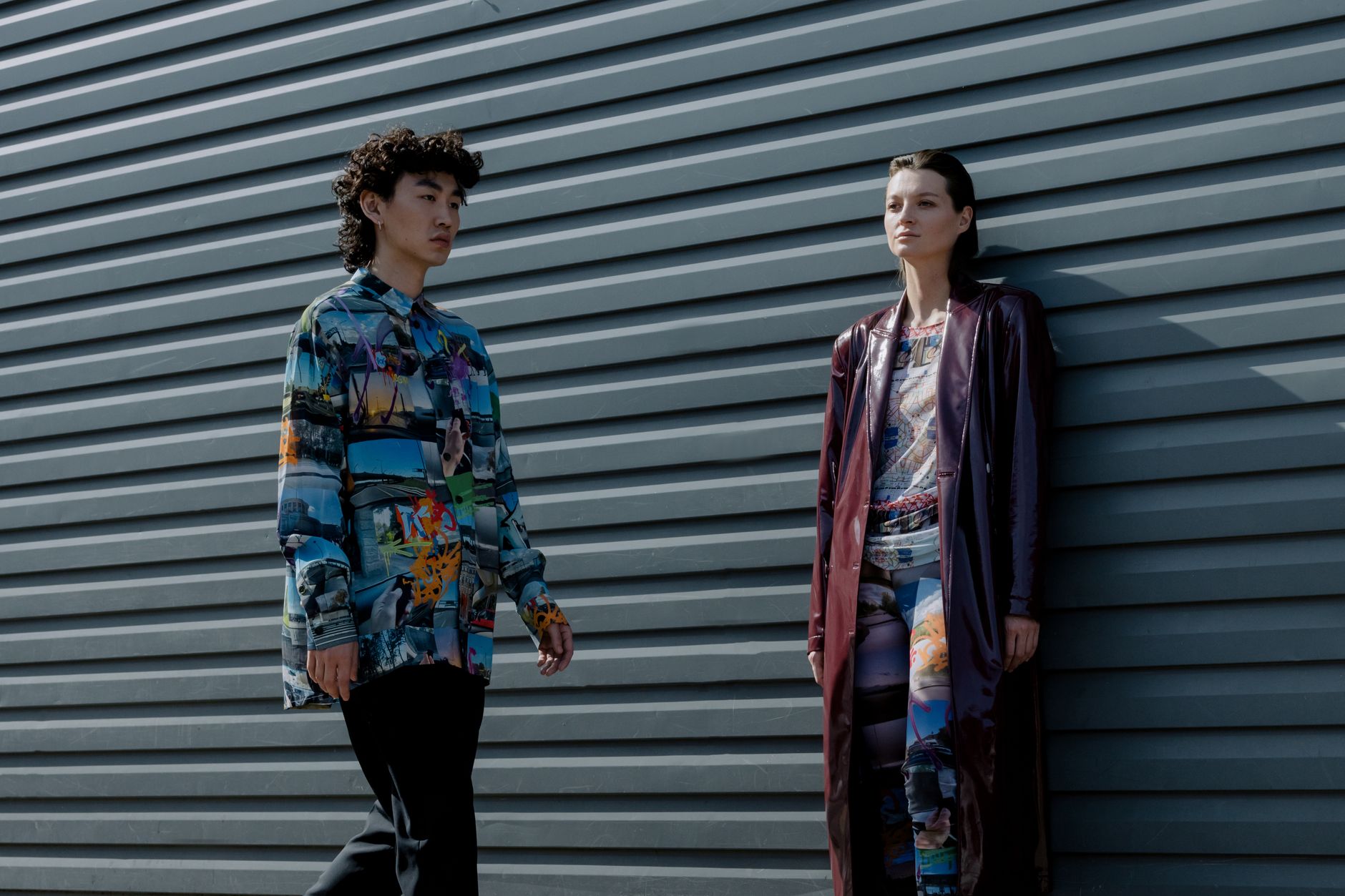 Stylish young models in colorful outfits posing against an urban backdrop.